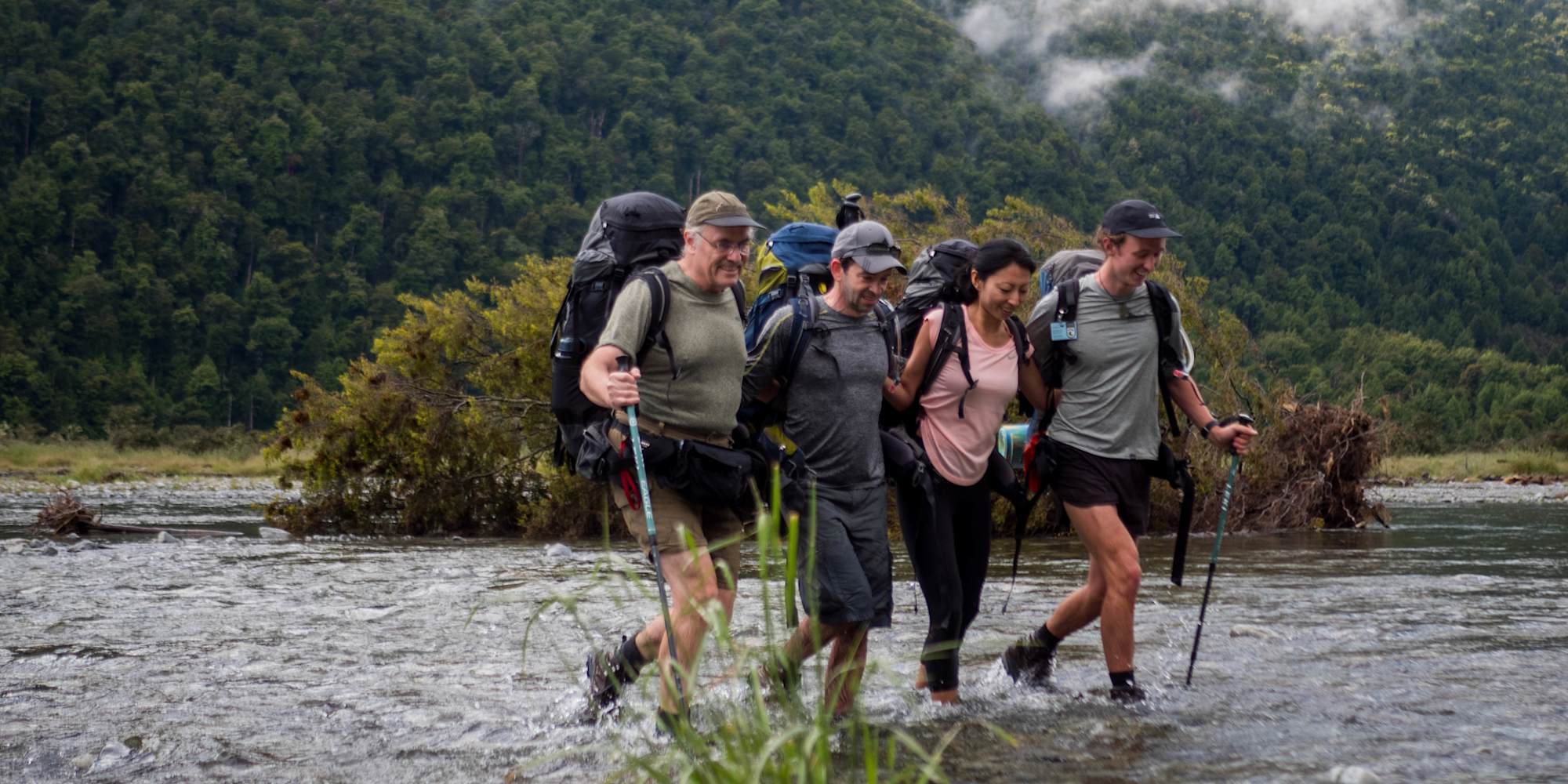 Guests hiking through a trail in Siberia Valley on the Classic South Island Active Adventures trip with their guide